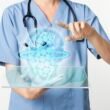 Doctors using transparent tablet with hologram medical technology